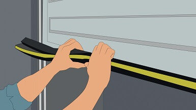 Drawing showing a man applying a roller shutter door seal to the bottom of a roller shutter door