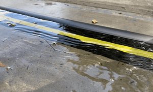 Close up of an installed 40mm garage door water barrier holding back rain