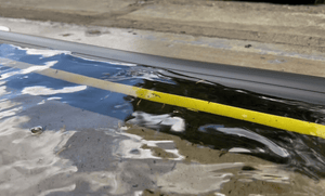 Water being stopped by the 50mm Garadam garage door flood barrier