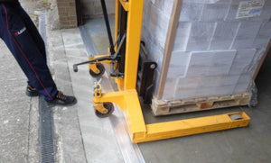Pallet stacker moving a lot of parcels over industrial strength aluminium threshold seal