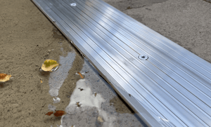 Industrial strength aluminium threshold seal holding back rain and debris